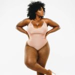 Olakemi - A curvy plus size model wearing a peach plus size once piece and plus size skin tone hosiery by @carnivalista