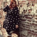 Melissa Jantina - Plus size model wearing a black plus size top with daises