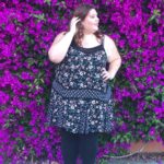 Melissa Jantina - Plus size model wearing a plus size flower top and black leggings