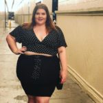 Melissa Jantina - Plus size model wearing a plus size black skirt and a black blouse with white polka-dots