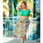 Laura Lee a plus size model is wearing plus size skirt and plus size green top