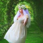 Curvy Model Ruby Roxx wearing a plus size white dress and wig by @rockstarwigs