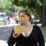 Plus size model Sarah Hamel-Smith aka TheCurvyTrini modeling a plus size black dress by @fashionnovacurve and sunglasses by @instyle-cosmo