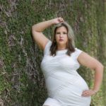 Plus size model Sarah Hamel-Smith aka TheCurvyTrini modeling a plus size white dress