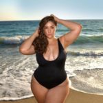 Plus Model Erica Lauren modeling a plus size one piece black swimsuit from @playfulpromises