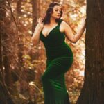 Curvy Model Ruby Roxx wearing a plus size green velvet dress