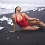 Plus Size Model Tabria Majors wearing a plus size one piece red swimsuit by @prettylittlething