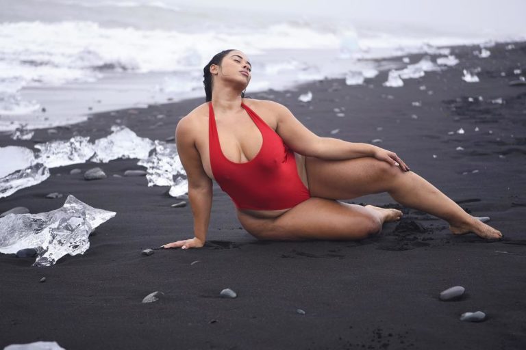 Plus Size Model Tabria Majors wearing a plus size one piece red swimsuit by @prettylittlething