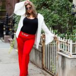 Plus size model Sarah Hamel-Smith aka TheCurvyTrini is wearing plus size red pants, a black top and a plus size white jacket by @sheinofficial