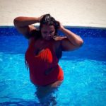 Kat Henry - Plus Size Model, Ms International Curve ‘17/18, Ms British Beauty Curve '15, Ridge Radio DJ,Blogger, Body Positive Activist - modeling a plus size red one piece swimsuit