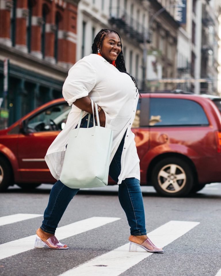 Plus size model Jezra Matthews (Jezra M) modeling plus size jeans and a plus size white top